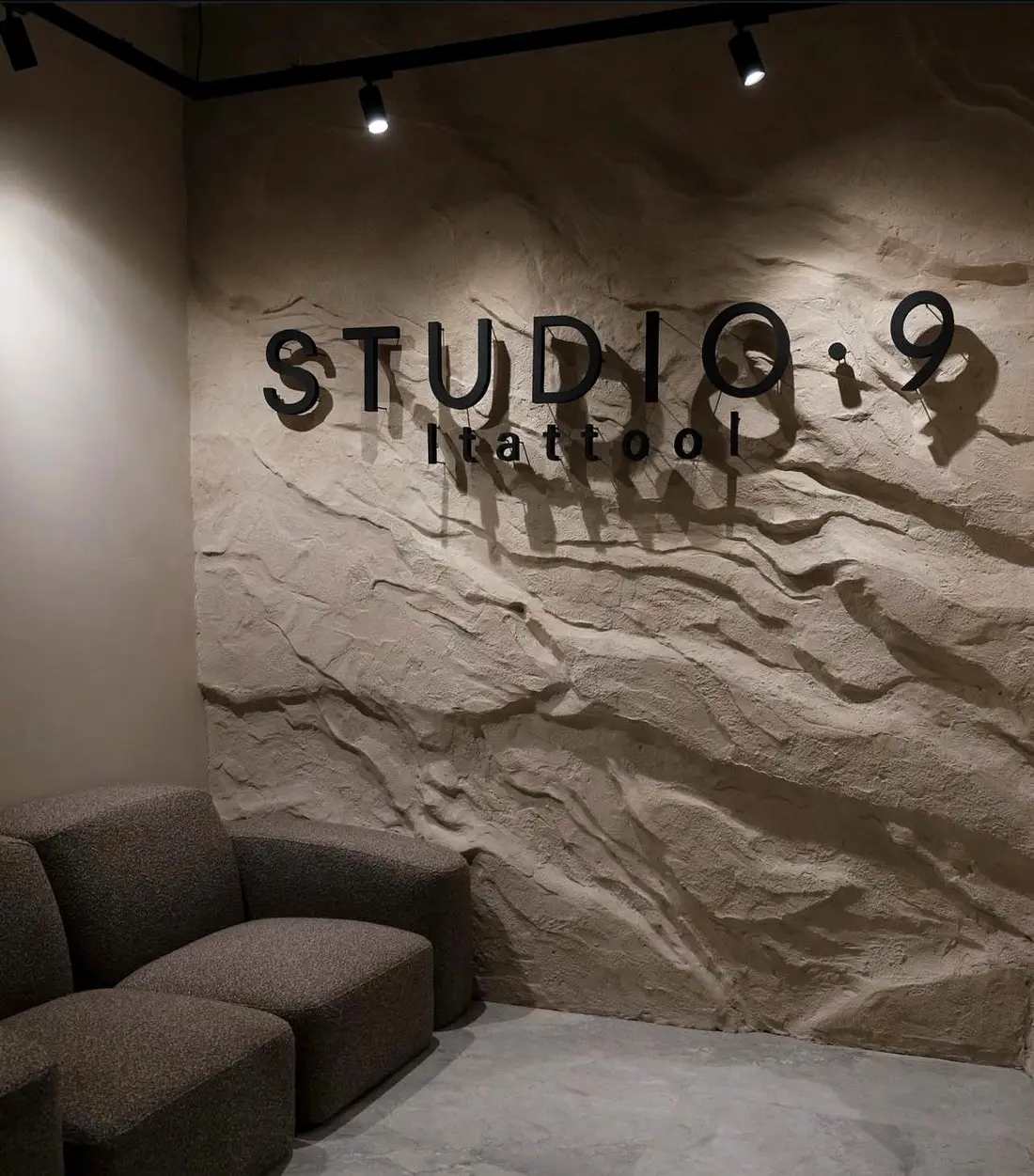 Hand-sculpted rock wall in a tattoo studio